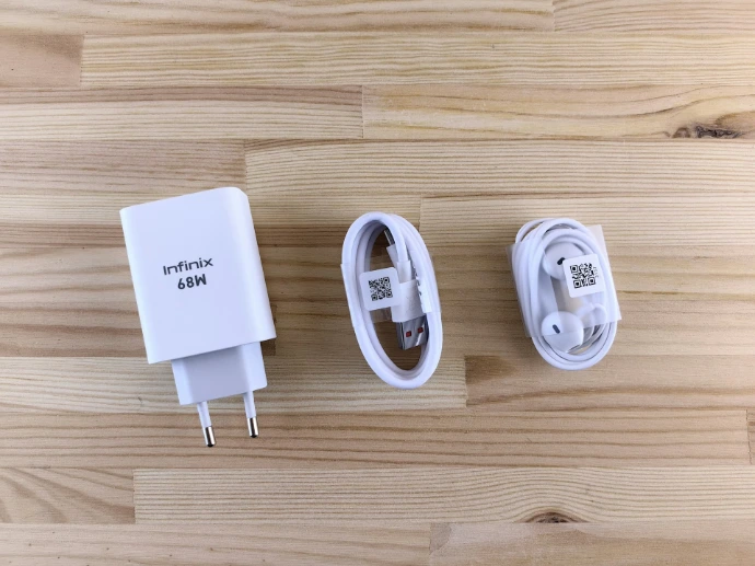 White smartphone charger, cable, and earphones on-ear headphones.